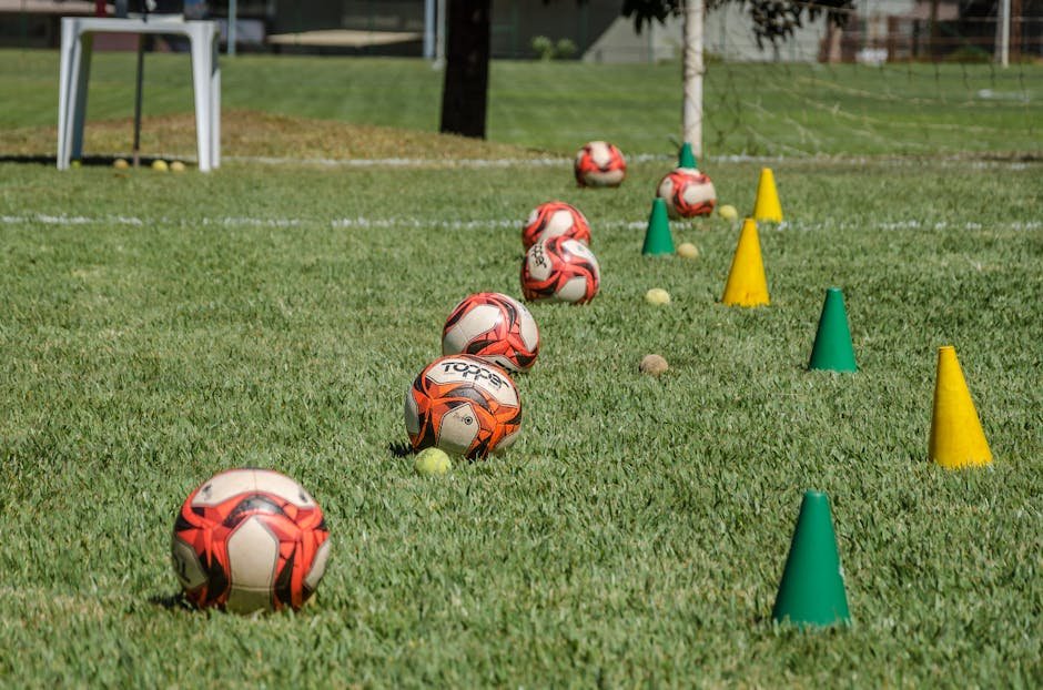pexels-photo-6658150-6658150 Soccer training equipment arranged on grass in Brasília, Brazil, featuring balls and cones.